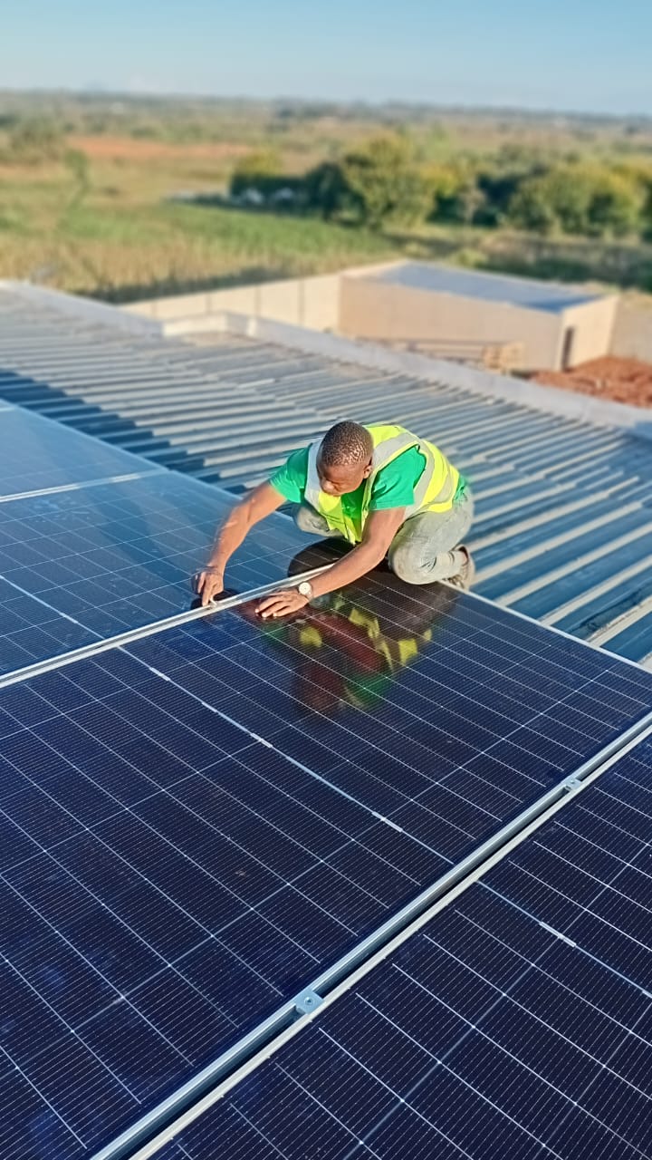 Massive industrial solar panel array on a warehouse rooftop